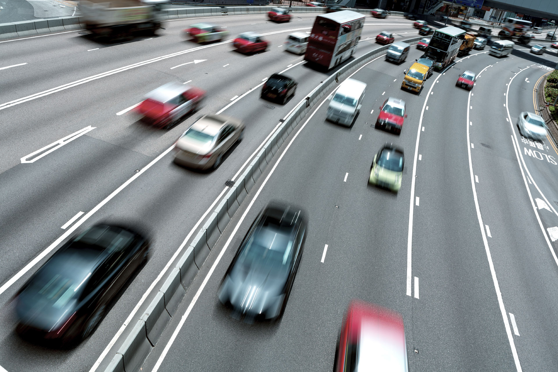 Traffic on a multi-lane highway in Hong Kong, illustrating Kapsch TrafficCom's managed lanes solution for optimizing traffic flow.